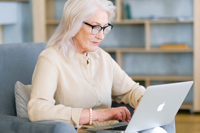 older woman with glasses on computer